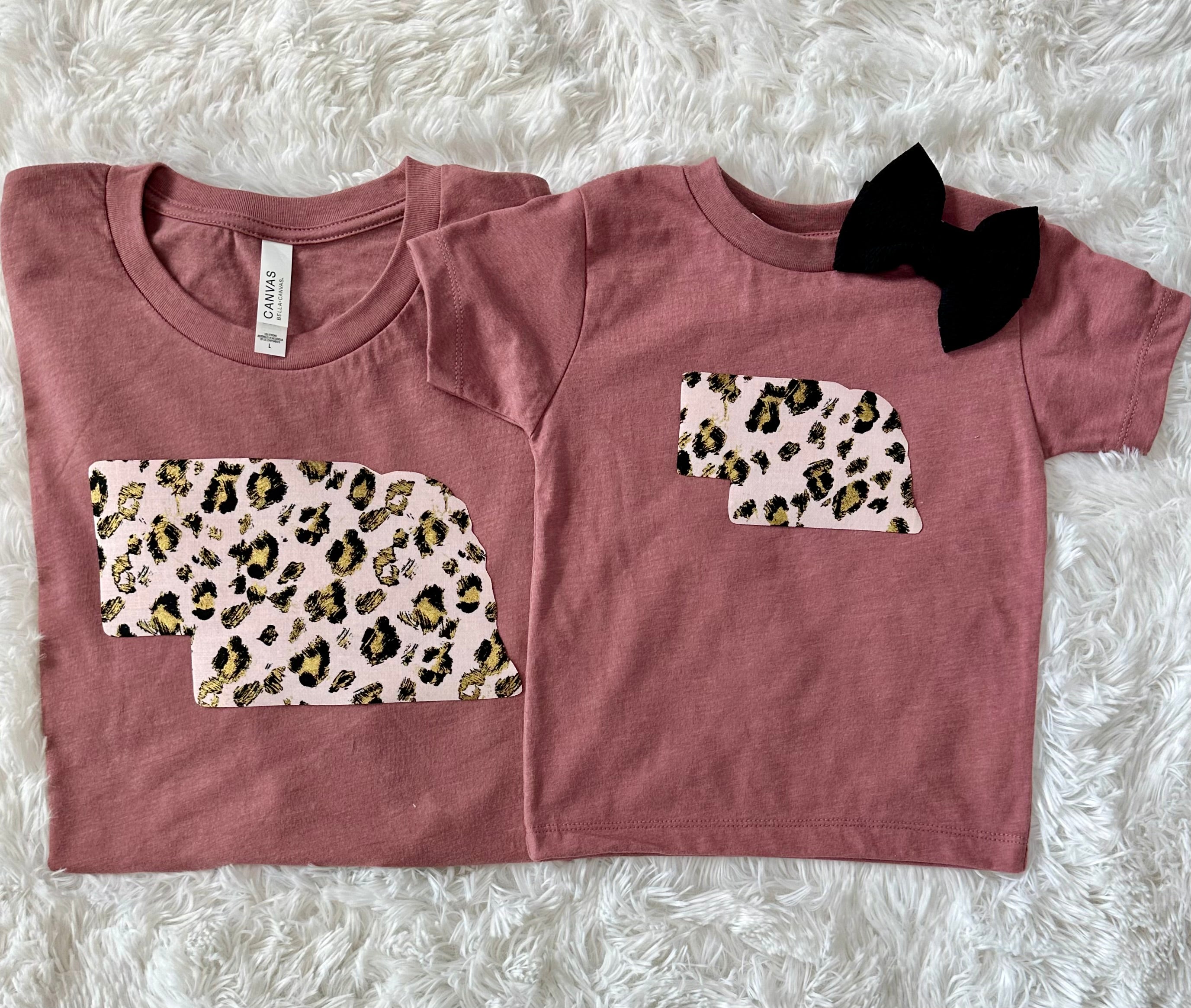 Pink Leopard State Tee on a Bella + Canvas shirt, featuring a unique hand-sewn state fabric design.