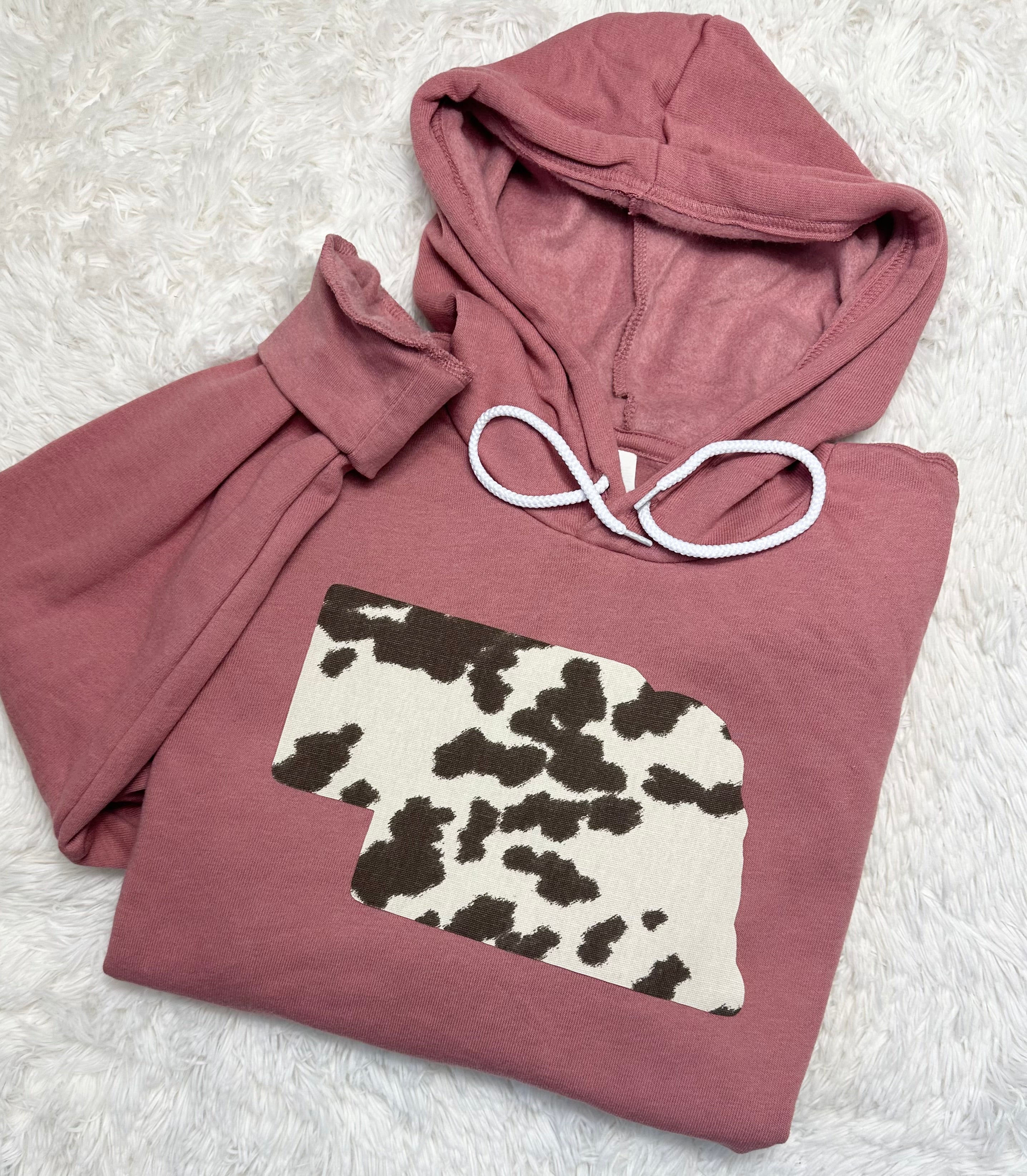 Cow State Mauve Hoodie featuring a unique hand-sewn cow state fabric design on premium Bella + Canvas unisex fit sweatshirts.
