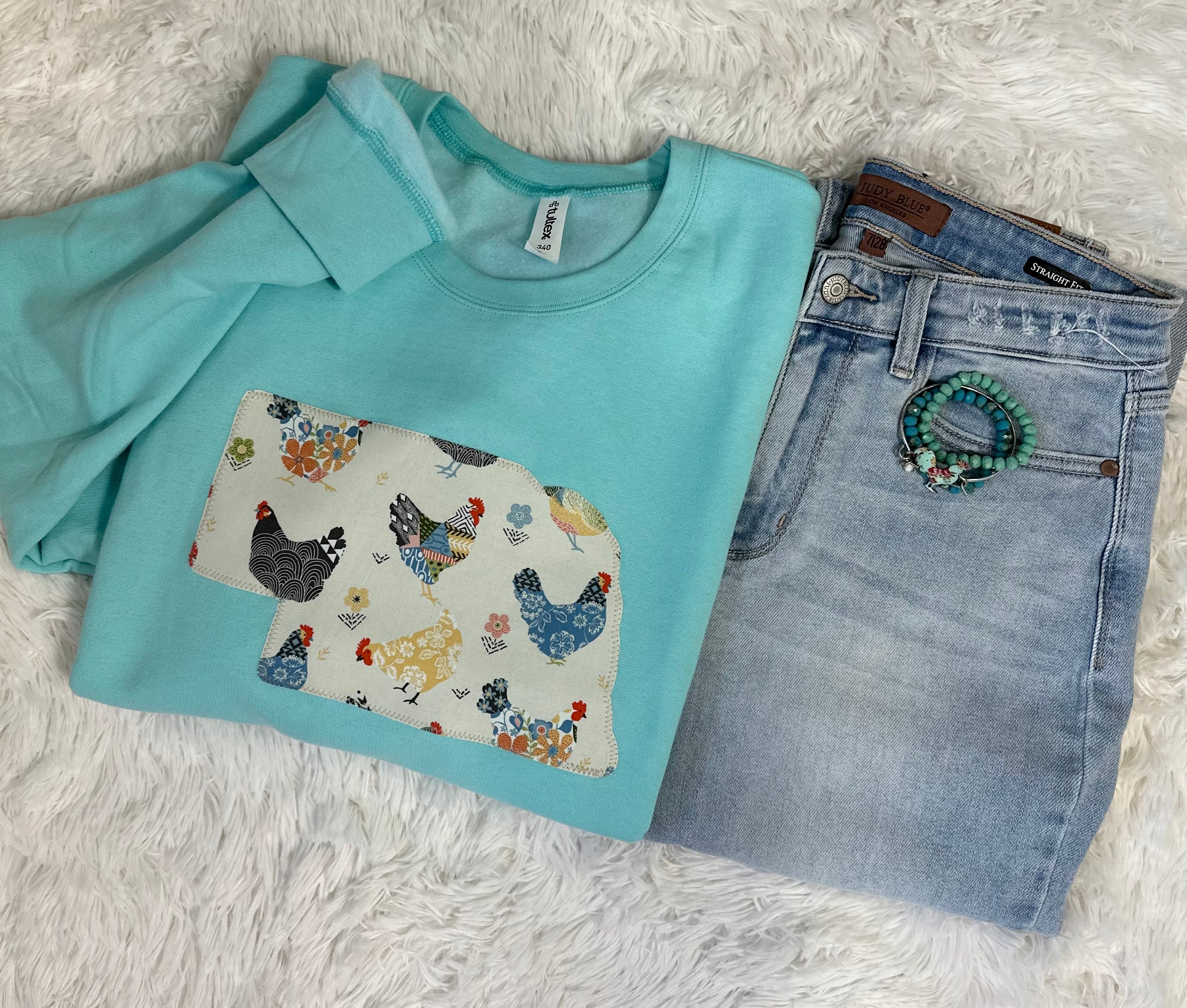 Chicken State Aqua Sweatshirt featuring a unique hand-sewn chicken design on unisex fit Jerzees and Gildan brand sweatshirts.