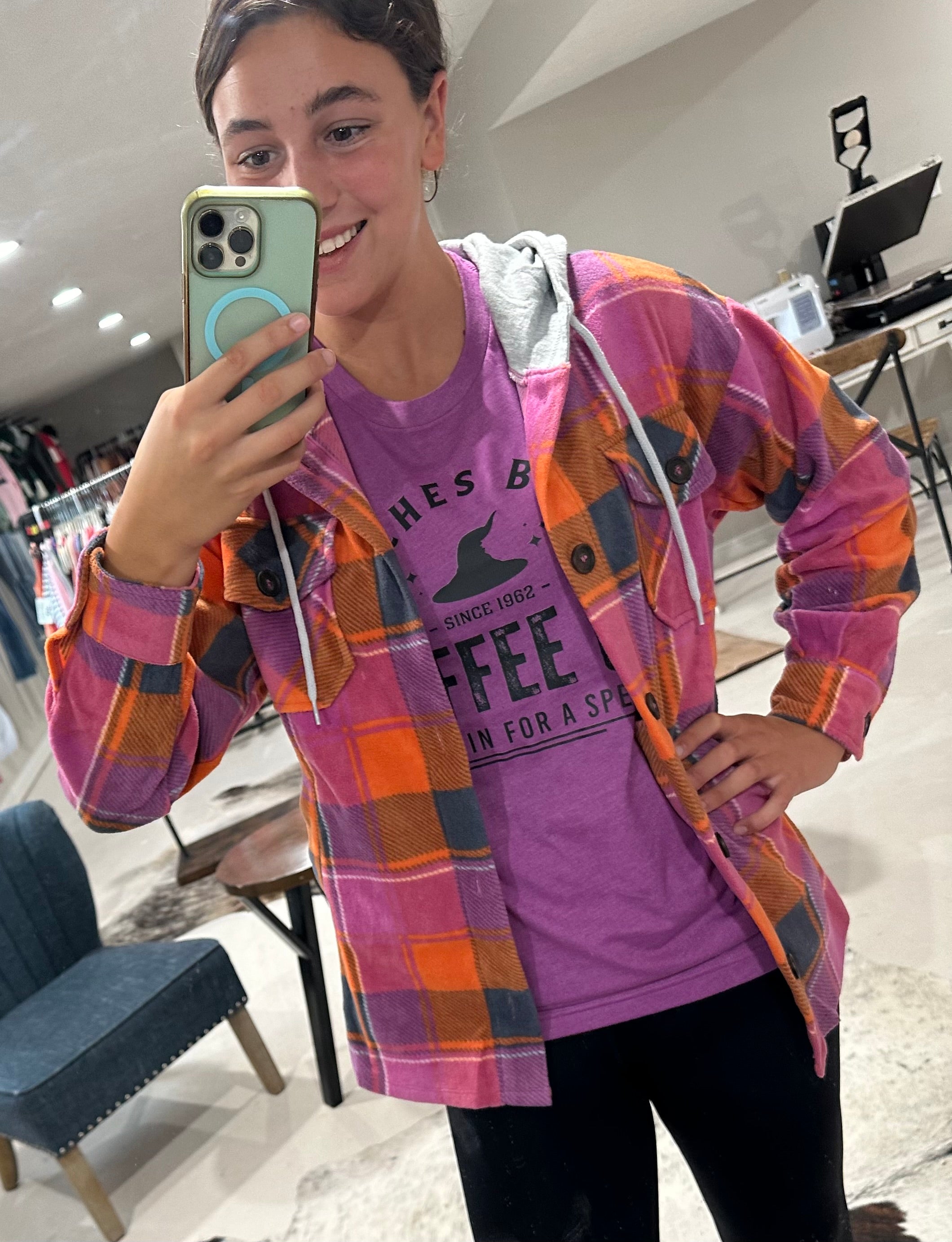 styled view of Witches Brew Coffee Tee with Halloween design, printed on Heather Magenta and Heather Autumn Bella + Canvas fabric.