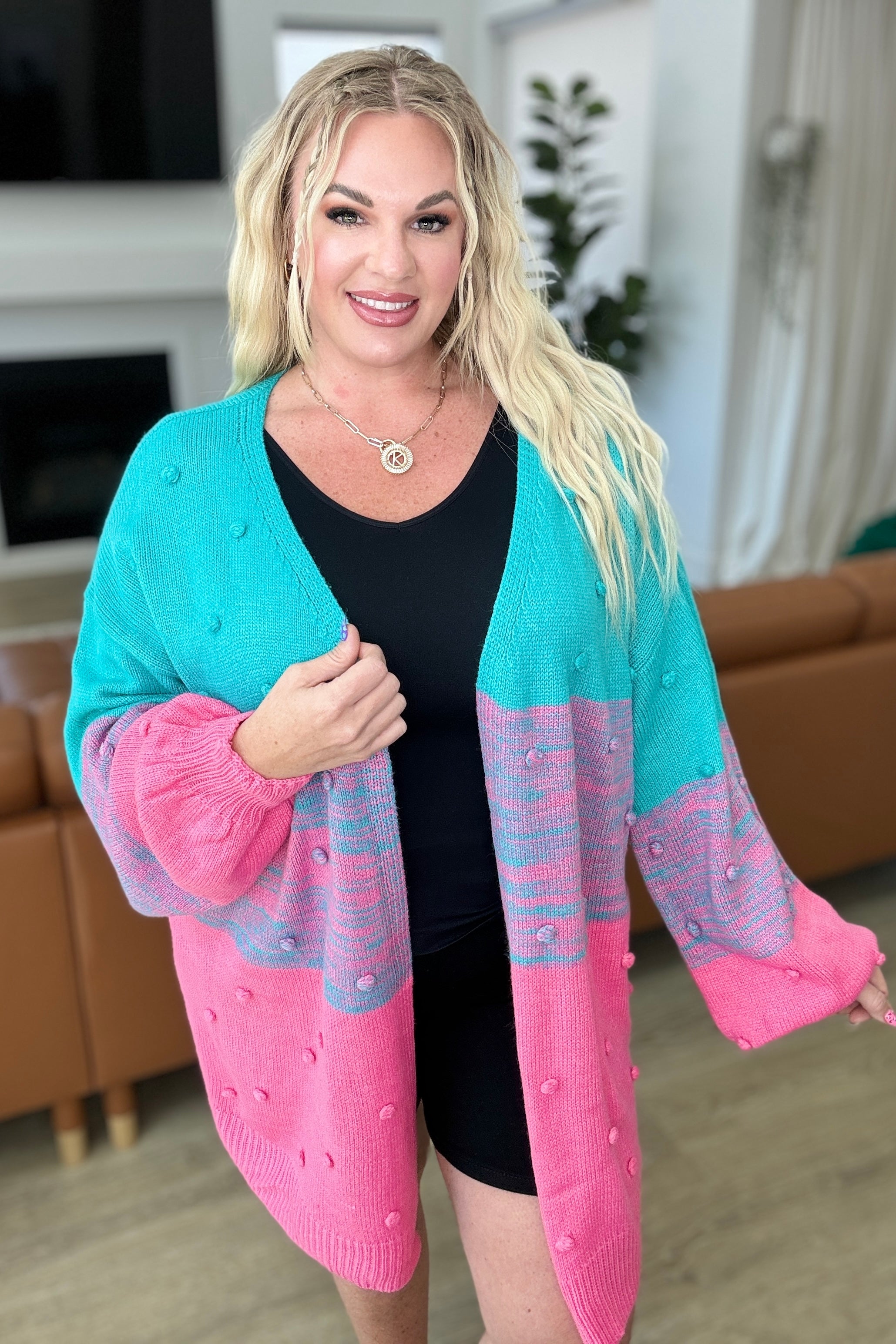 plus size front view of When We're Grooving Open Front Cardigan with ombre stripes, pom pom accents, and balloon sleeves for a cozy and stylish look.