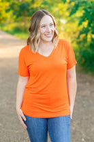 example of Chloe Cozy Ghost Tee with stitched ghost detail on chest, V-neckline, longer short sleeves, and relaxed fit. Made from a soft blend of rayon and spandex.