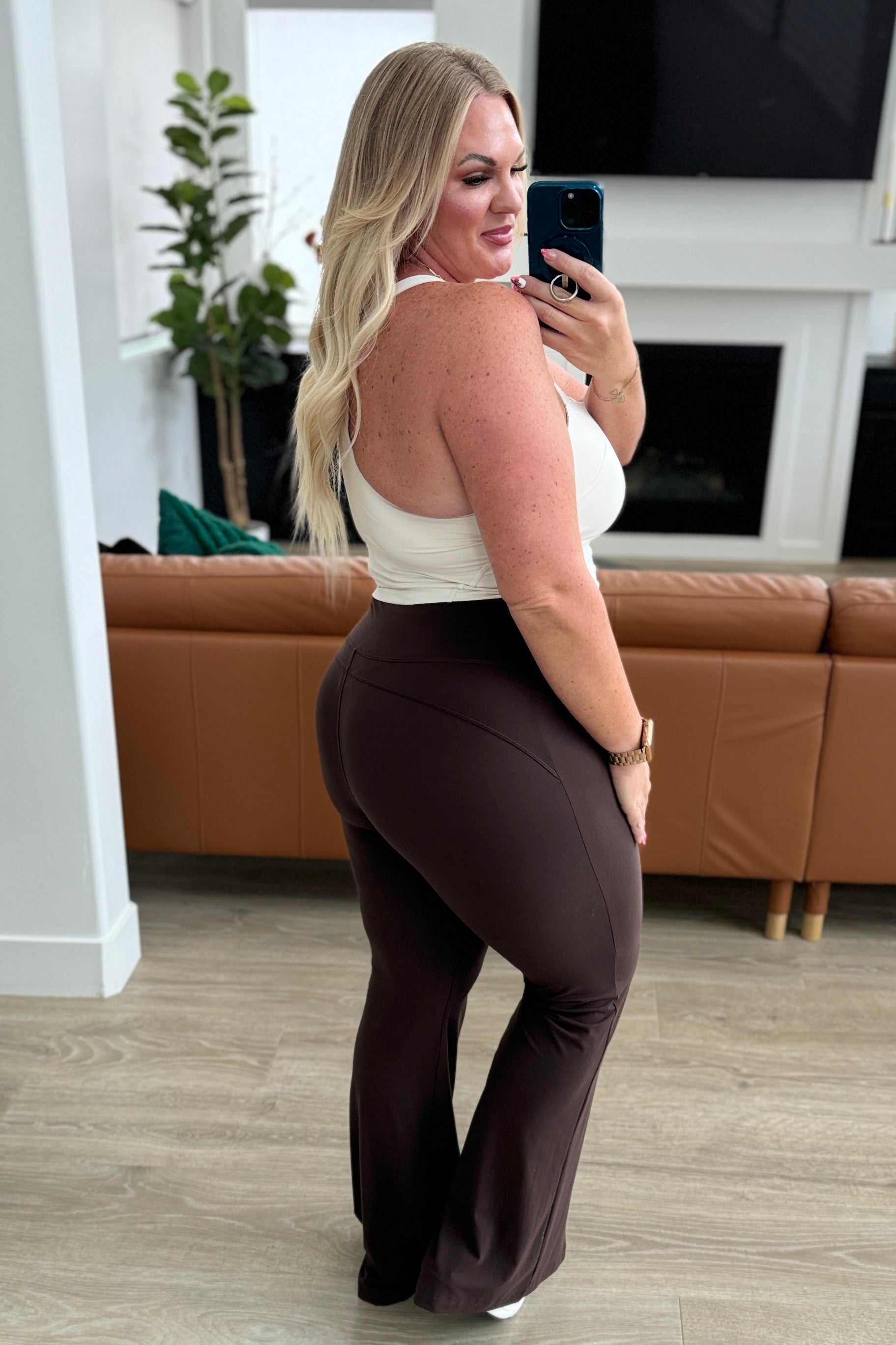 plus size side view of Stamina Stride flare leggings in Espresso, high waist with coin pocket, front slit, brushed microfiber fabric, shown in various sizes