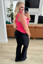 side view of Stamina Stride Flare Leggings with a high waist, thick waistband, and flare leg with front slit. Made from brushed microfiber for high stretch and comfort.
