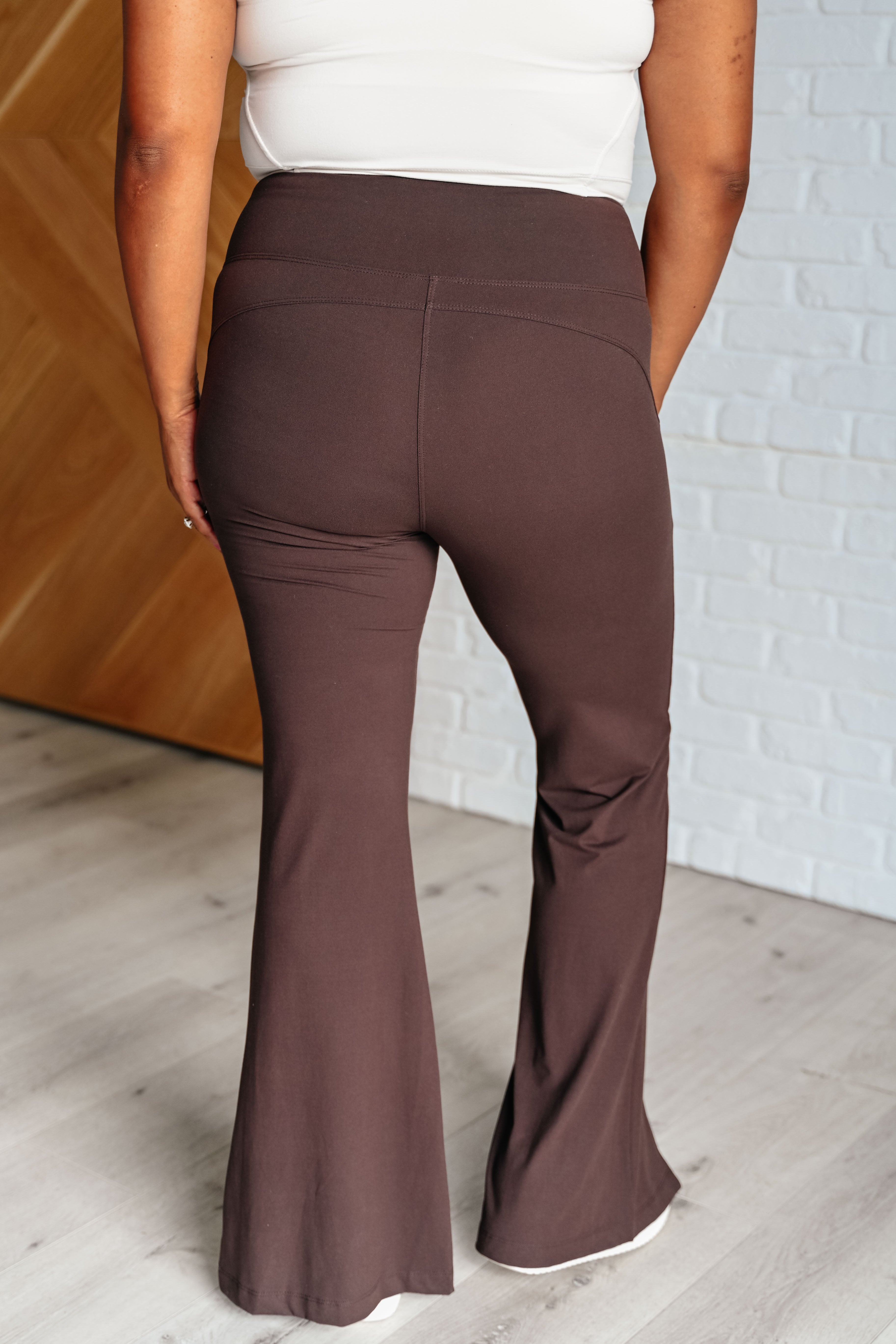 plus size back view of Stamina Stride flare leggings in Espresso, high waist with coin pocket, front slit, brushed microfiber fabric, shown in various sizes